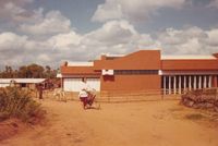 Woman on bicycle in front of Auropress building