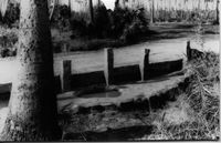 Side of raised road with granite pillars