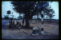 Road junction signs with people waiting